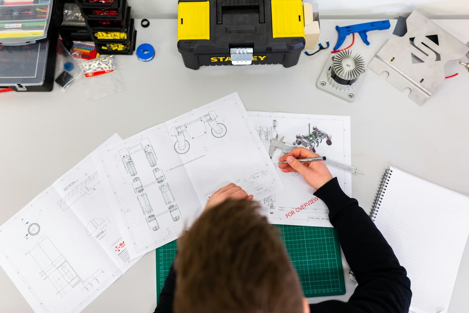 Engineering workbench with product drawings and hardware tools